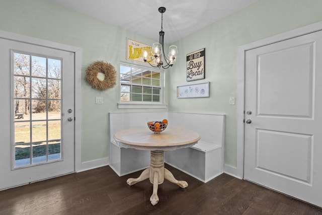 dining area with baseboards, breakfast area, a chandelier, and dark wood-style floors