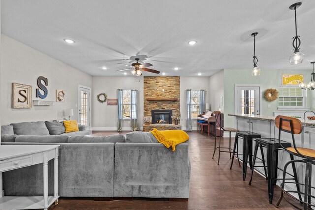 living room featuring a ceiling fan, plenty of natural light, recessed lighting, and a fireplace