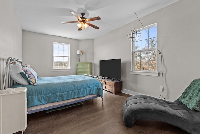 bedroom featuring baseboards, ceiling fan, and wood finished floors