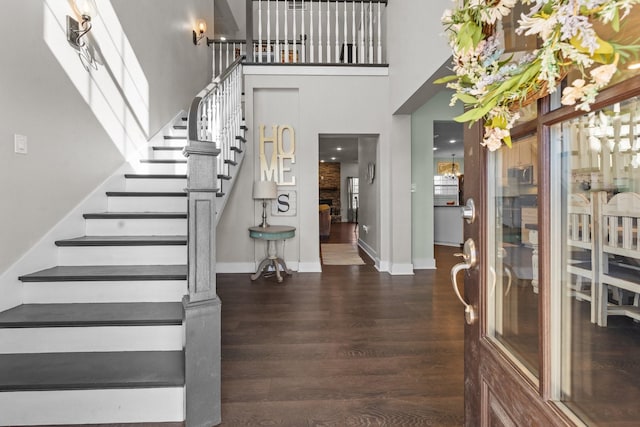 entryway featuring a high ceiling and dark hardwood / wood-style floors