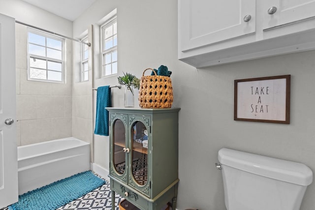 full bathroom featuring tile patterned floors, bathing tub / shower combination, and toilet