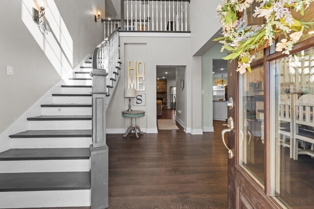 foyer featuring french doors, dark hardwood / wood-style floors, and a towering ceiling