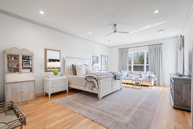 bedroom with crown molding, ceiling fan, and light hardwood / wood-style floors