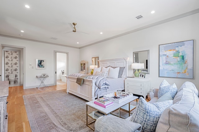 bedroom with ceiling fan, ornamental molding, connected bathroom, and light wood-type flooring