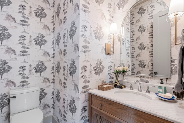 8010 Eagle Trl, Dallas, TX 75238 - bathroom featuring wallpapered walls, vanity, and toilet
