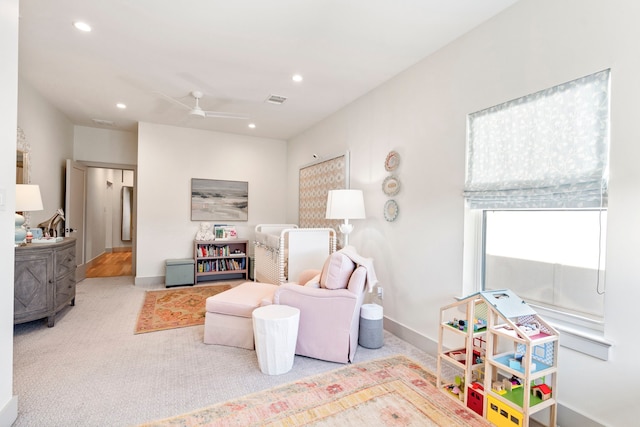 game room featuring ceiling fan and light colored carpet