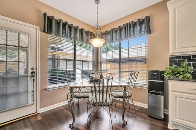 dining space with dark hardwood / wood-style flooring