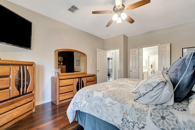 bedroom featuring ceiling fan, dark hardwood / wood-style flooring, and ensuite bath