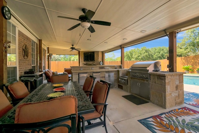 view of patio / terrace featuring an outdoor kitchen, a grill, and ceiling fan