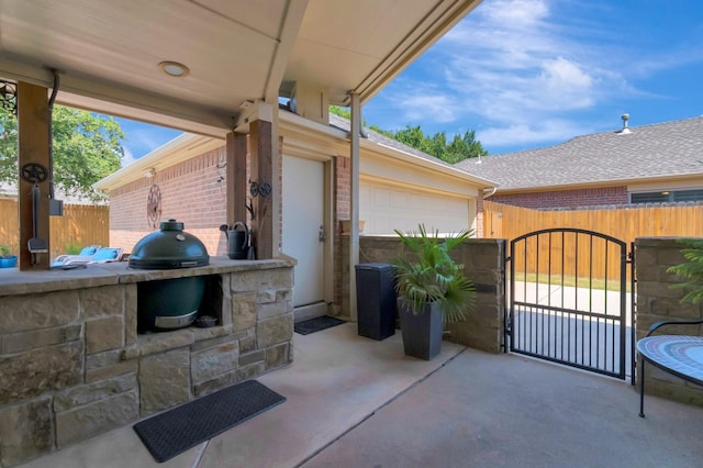 view of patio / terrace featuring a garage, area for grilling, and grilling area