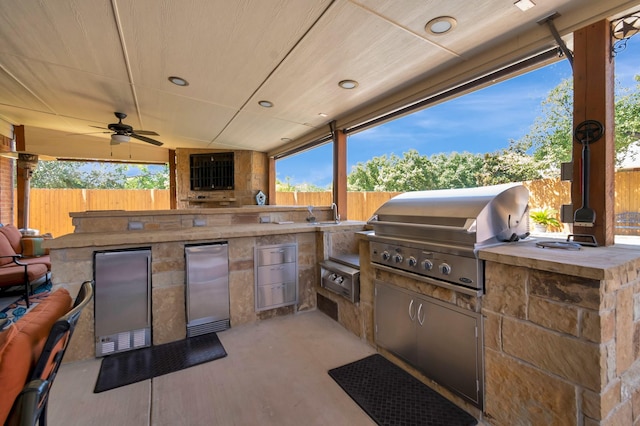 view of patio / terrace featuring ceiling fan, grilling area, and exterior kitchen