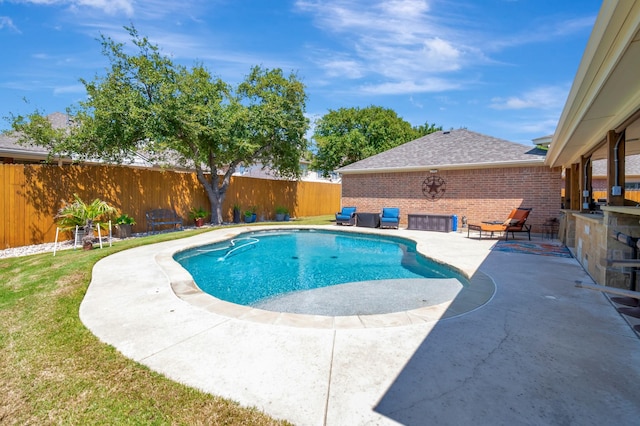 view of swimming pool featuring a yard and a patio area