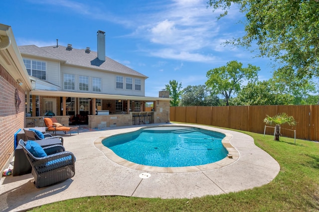 view of swimming pool featuring a patio, an outdoor hangout area, an outdoor bar, and a lawn