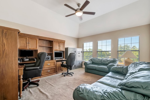 carpeted office space featuring vaulted ceiling, a wealth of natural light, and ceiling fan