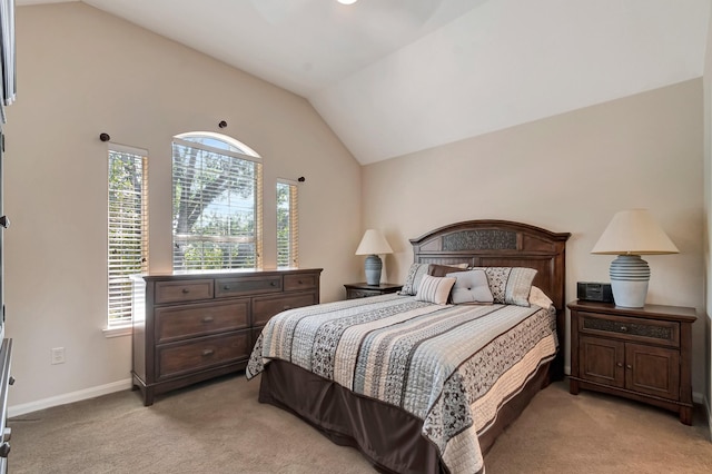 bedroom featuring vaulted ceiling and light colored carpet