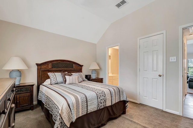 carpeted bedroom with lofted ceiling and ensuite bathroom