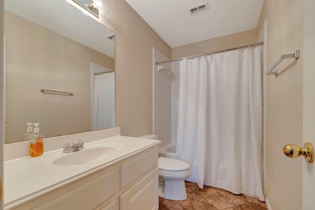 full bathroom featuring vanity, shower / bath combo, and toilet