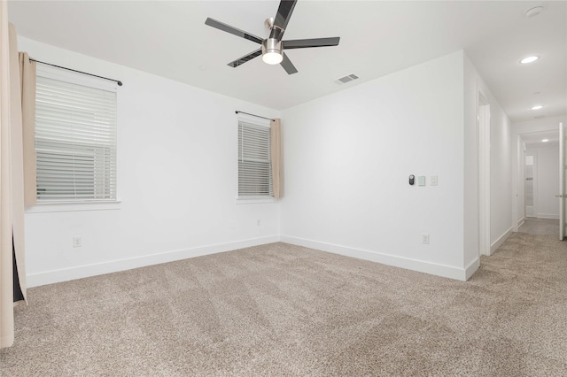 unfurnished room featuring recessed lighting, visible vents, light carpet, ceiling fan, and baseboards