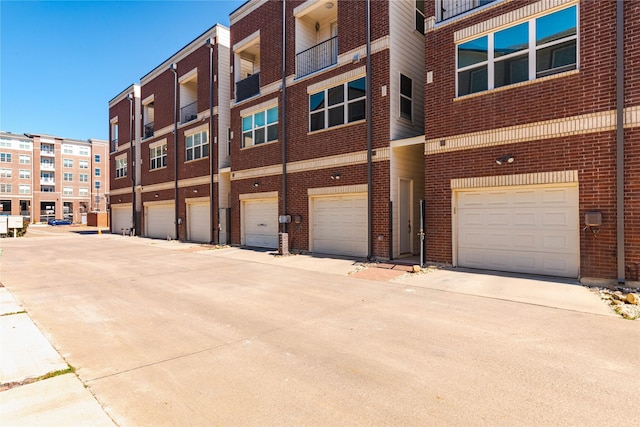 view of property with a garage and driveway