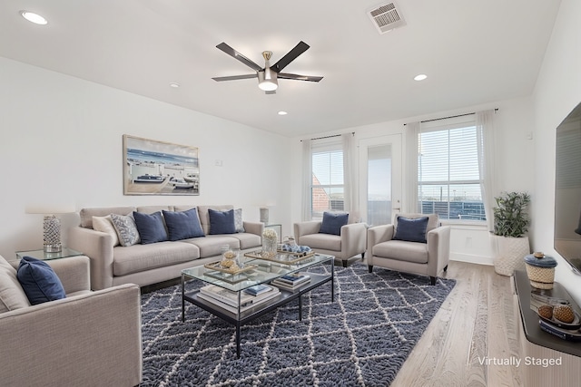 living area with a ceiling fan, recessed lighting, visible vents, and wood finished floors