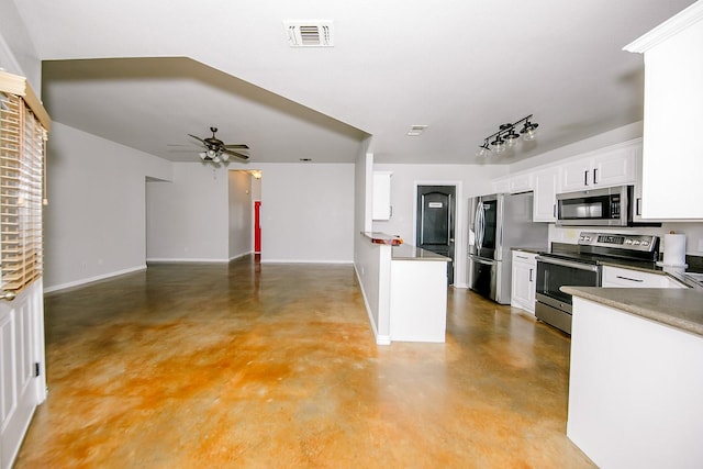 kitchen with appliances with stainless steel finishes, white cabinets, and ceiling fan