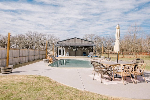 view of swimming pool with a patio area