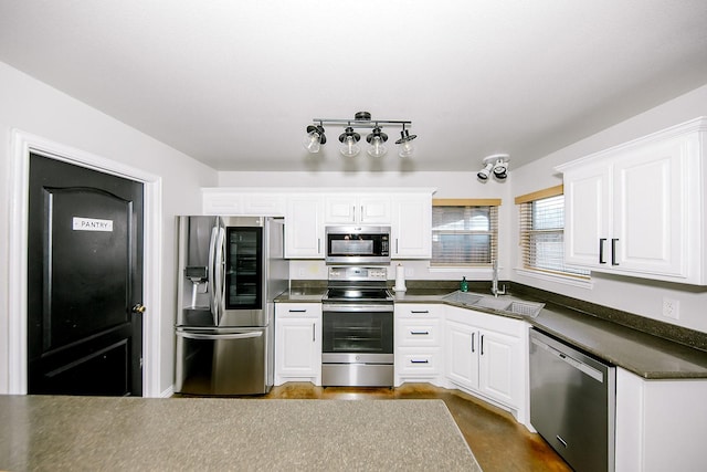 kitchen featuring sink, white cabinets, and appliances with stainless steel finishes