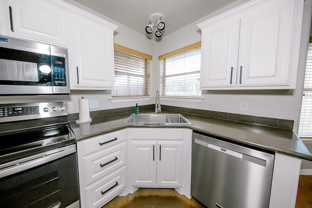 kitchen with white cabinetry, appliances with stainless steel finishes, and sink