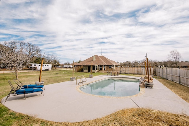 view of pool with a patio and a lawn