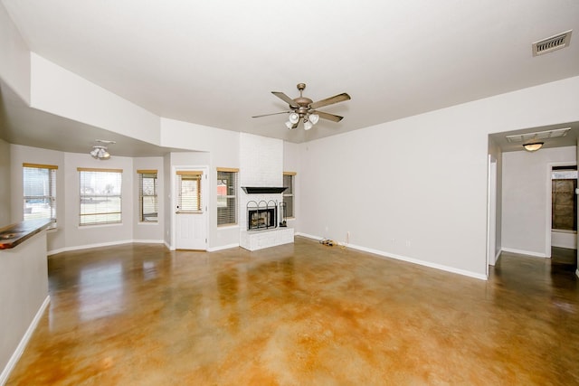 unfurnished living room featuring ceiling fan, a fireplace, and concrete flooring