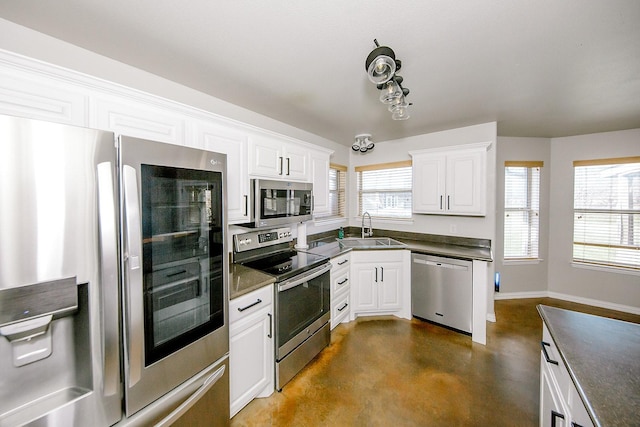 kitchen with white cabinetry, appliances with stainless steel finishes, and sink