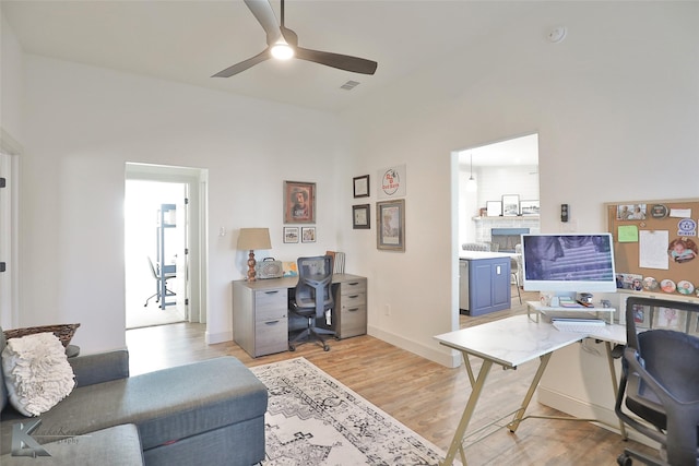 office area with ceiling fan and light wood-type flooring