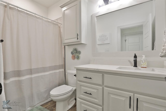 bathroom featuring vanity, a shower with curtain, toilet, and hardwood / wood-style flooring