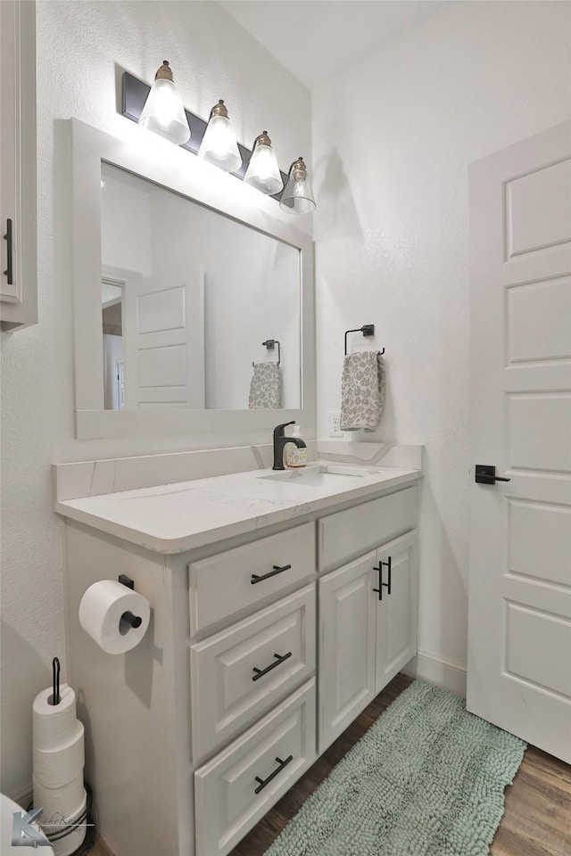 bathroom with vanity and hardwood / wood-style floors