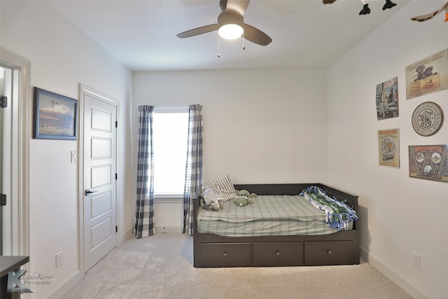 bedroom featuring light carpet and ceiling fan