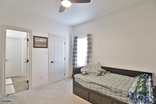 bedroom featuring light colored carpet and ceiling fan