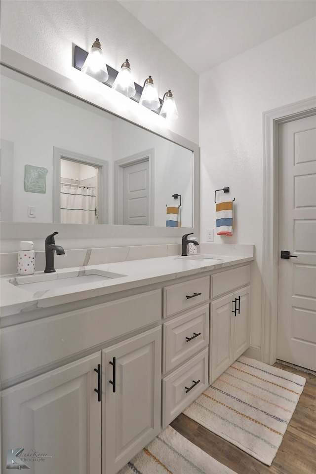 bathroom with vanity and hardwood / wood-style floors