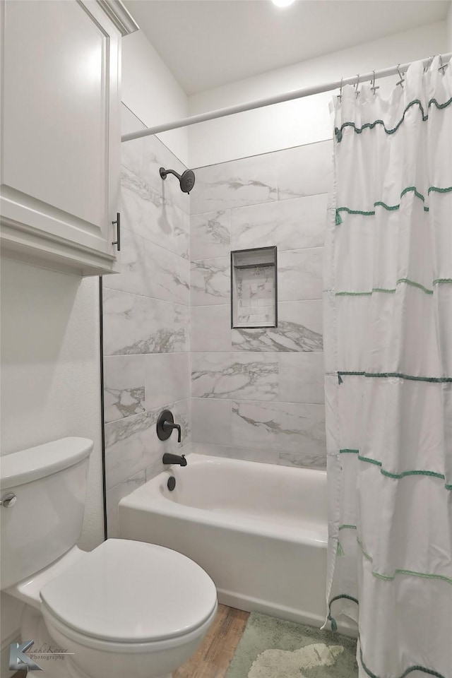 bathroom featuring shower / bathtub combination with curtain, toilet, and hardwood / wood-style floors