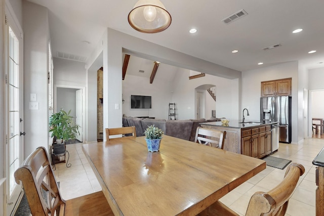 dining space featuring sink and light tile patterned floors