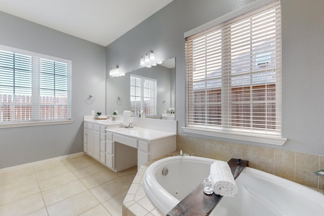 bathroom with vanity, a relaxing tiled tub, a wealth of natural light, and tile patterned floors