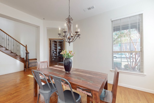 1240 Wedgewood Dr, Forney, TX 75126 - dining room featuring baseboards, a chandelier, stairway, light wood-style floors, and visible vents