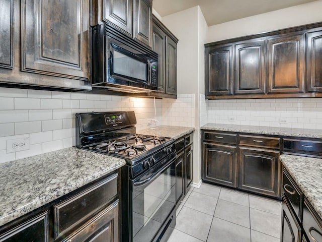 kitchen with black appliances, light stone counters, backsplash, and dark brown cabinets