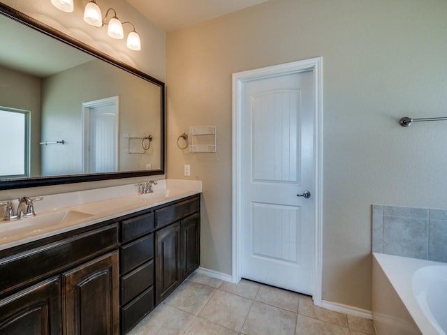 bathroom with double vanity, tile patterned flooring, a sink, and a bath