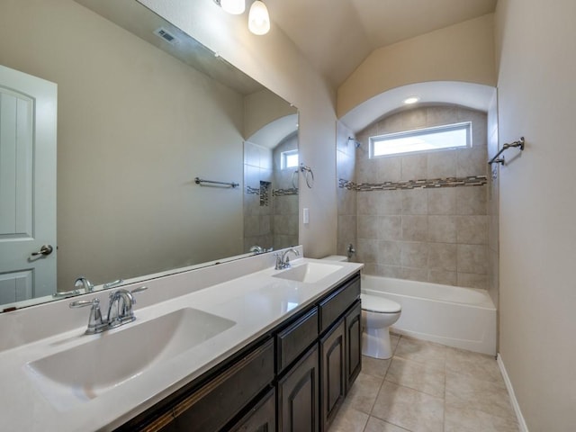 full bath featuring double vanity, a sink, toilet, and tile patterned floors