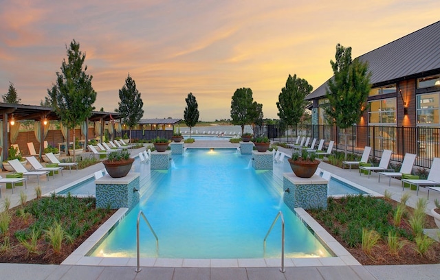 community pool featuring a patio and fence