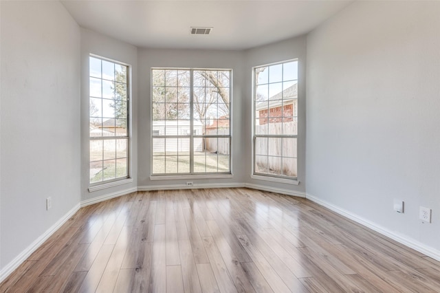 unfurnished dining area featuring plenty of natural light and light hardwood / wood-style flooring