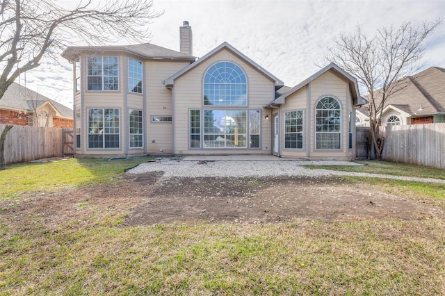 rear view of property featuring a patio area and a lawn