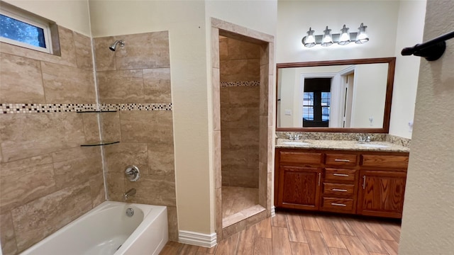 bathroom featuring vanity and tiled shower / bath combo