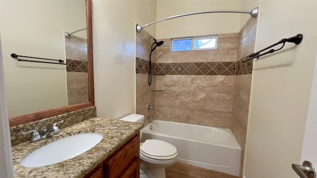 full bathroom featuring vanity, toilet, and tiled shower / bath combo