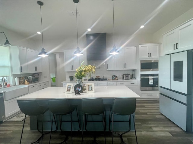 kitchen featuring light countertops, appliances with stainless steel finishes, and white cabinets